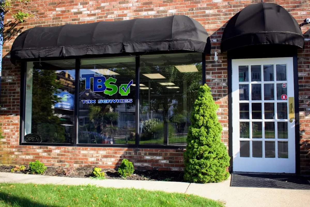 TBS Tax Services storefront with brick facade and black awning
